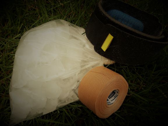 ice, tape, and brace on grass; used in sports injuries