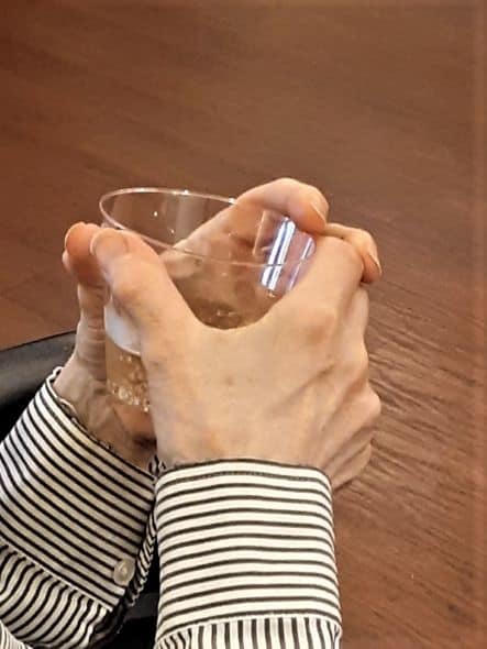 geriatric hands holding a drink