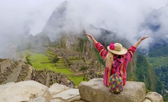 Patti overlooking Machu Picchu, arms aloft