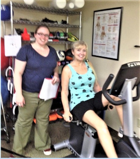Shanan Brissette, PT, DPT with Patti Morrow on the stationary bike